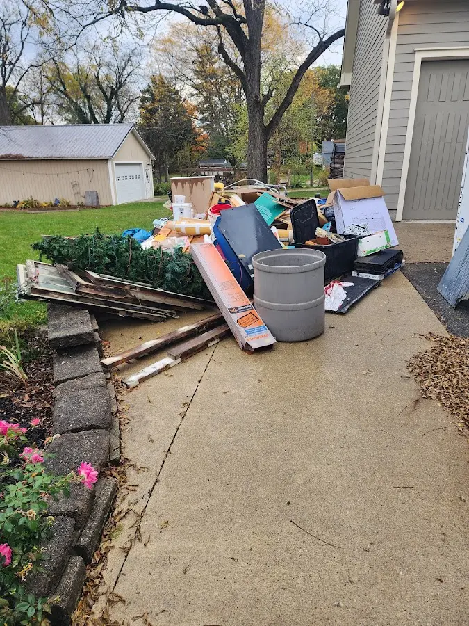 Dumpster being loaded with debris for 12 Yard Dumpster Rental in Windsor Locks
